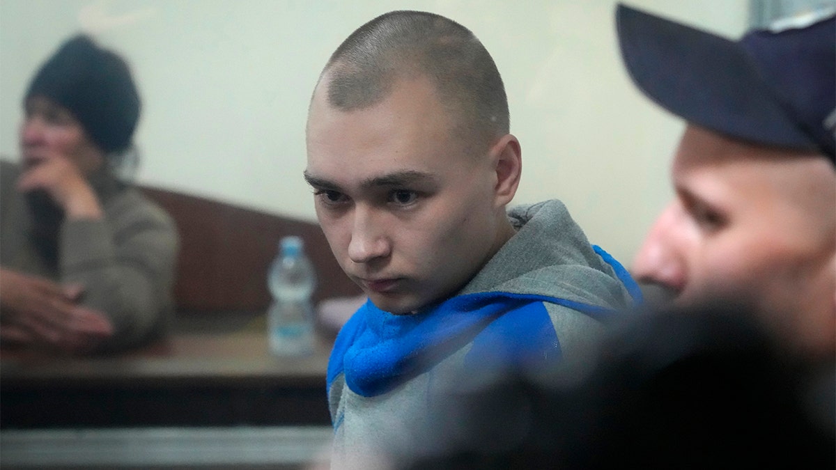 Russian army Sergeant Vadim Shishimarin, 21, is seen behind a glass during a court hearing in Kyiv, Ukraine, Wednesday, May 18, 2022. 