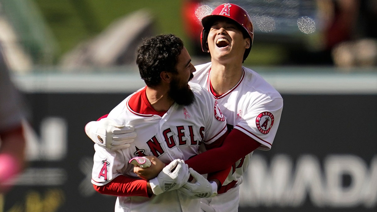 Los Angeles Angels designated hitter Shohei Ohtani (17) celebrates with Anthony Rendon (6) after a 5-4 win over the Washington Nationals in a baseball game in Anaheim, Calif., Sunday, May 8, 2022. Rendon hit a walk-off single, allowing Ohtani to score.