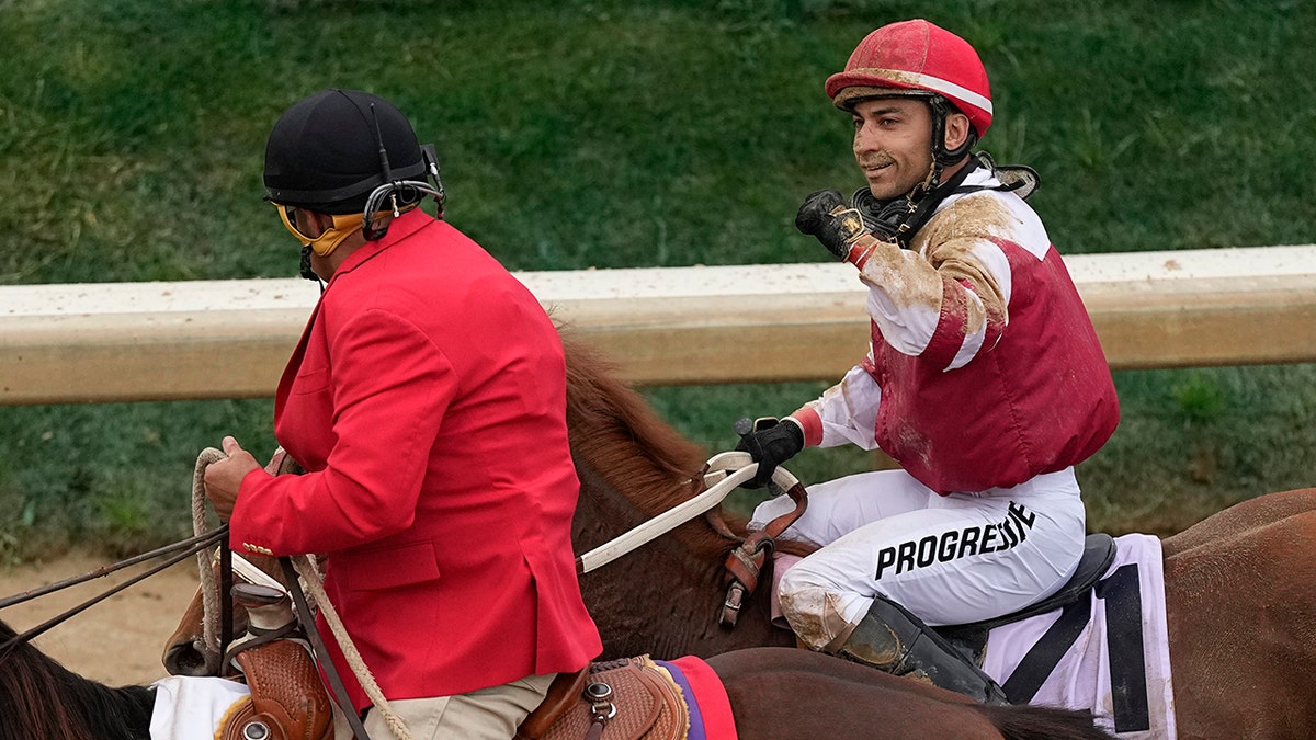 Rich Strike (21), with Sonny Leon aboard, is led to the winner's circle after winning the 148th running of the Kentucky Derby horse race at Churchill Downs Saturday, May 7, 2022, in Louisville, Ky.