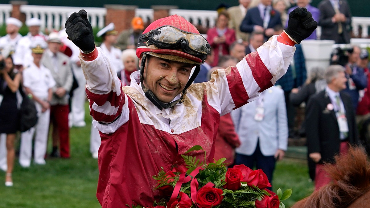 Jockey Sonny Leon celebrates in the winner's circle after Rich Strike won the 148th running of the Kentucky Derby horse race at Churchill Downs, Saturday, May 7, 2022, in Louisville, Ky. 