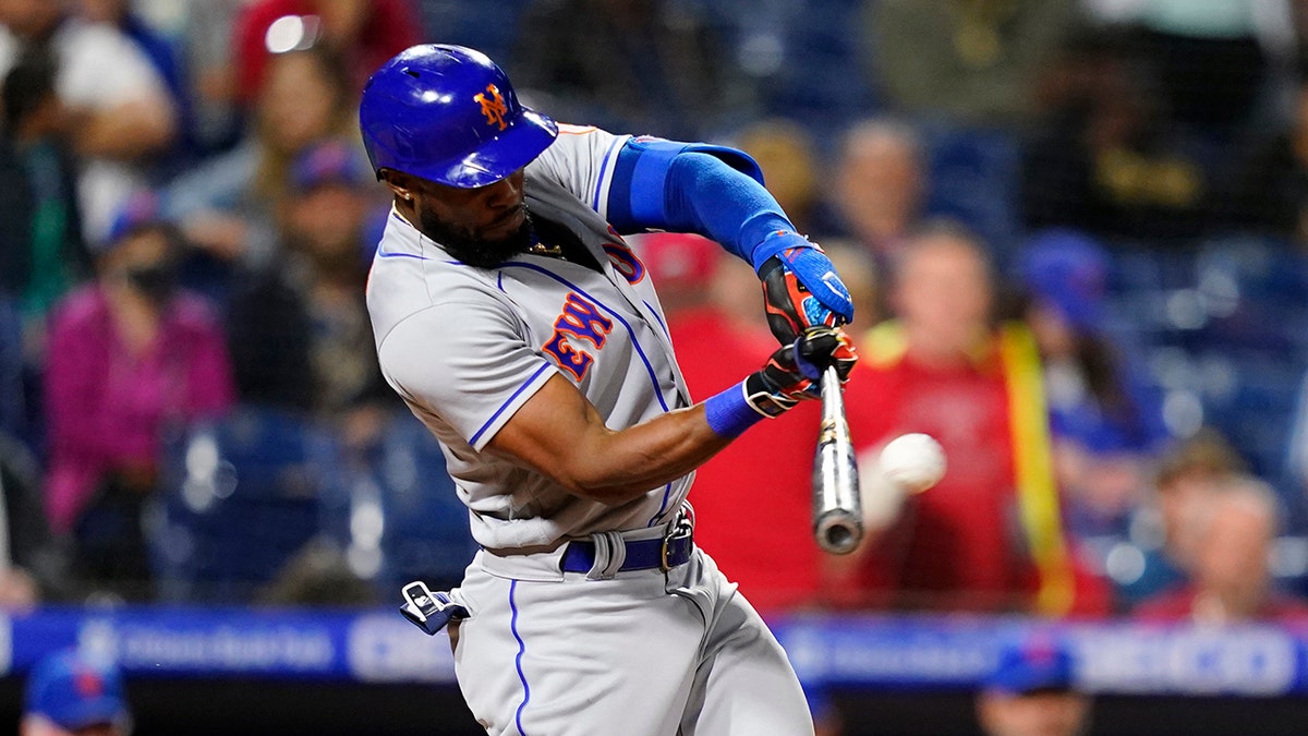 New York Mets' Starling Marte hits a run-scoring double against Philadelphia Phillies pitcher Corey Knebel during the ninth inning of a baseball game, Thursday, May 5, 2022, in Philadelphia. 