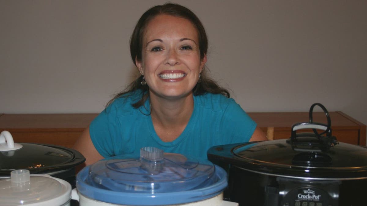 Stephanie ODea poses with 3 Crockpot slow cookers