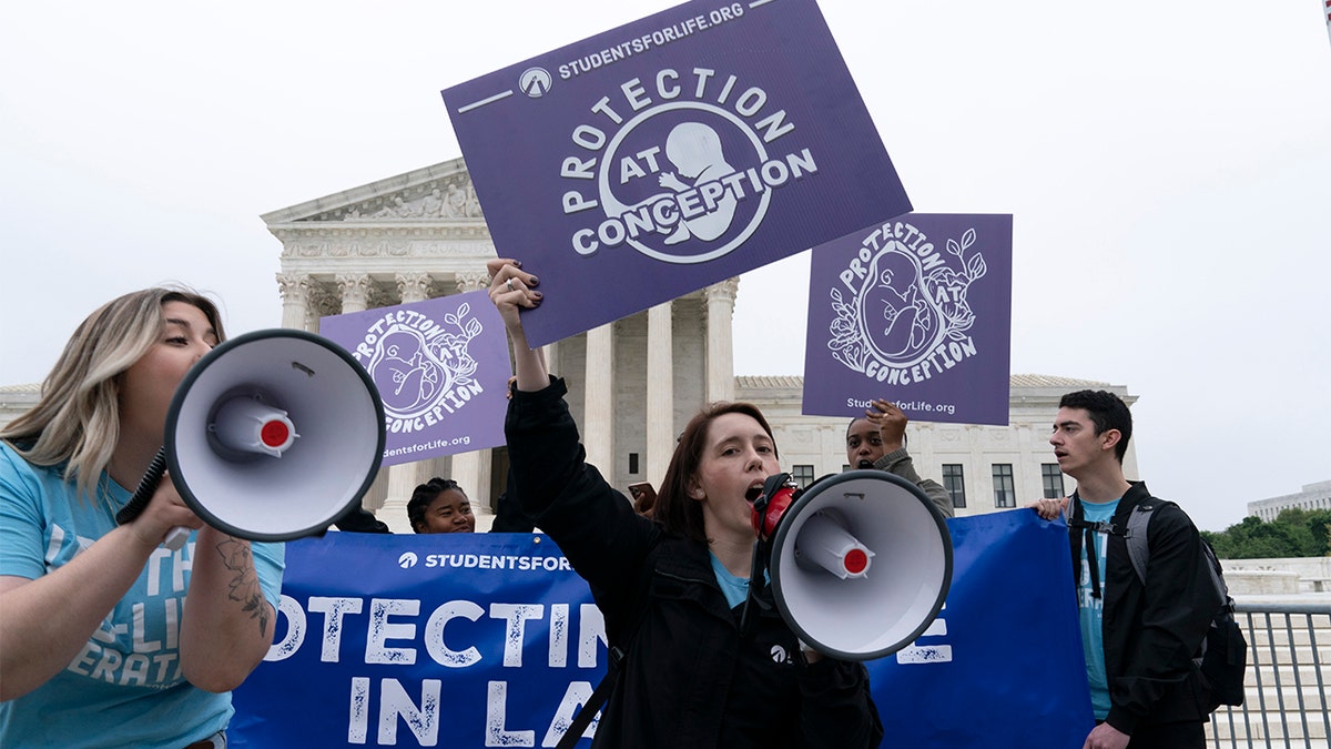 Demonstrators protest outside of the U.S. Supreme Court Tuesday, May 3, 2022 in Washington. (AP Photo/Jose Luis Magana)