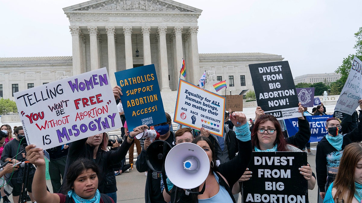 Demonstrators protest outside of the U.S. Supreme Court Tuesday, May 3, 2022 in Washington. (AP Photo/Jose Luis Magana)
