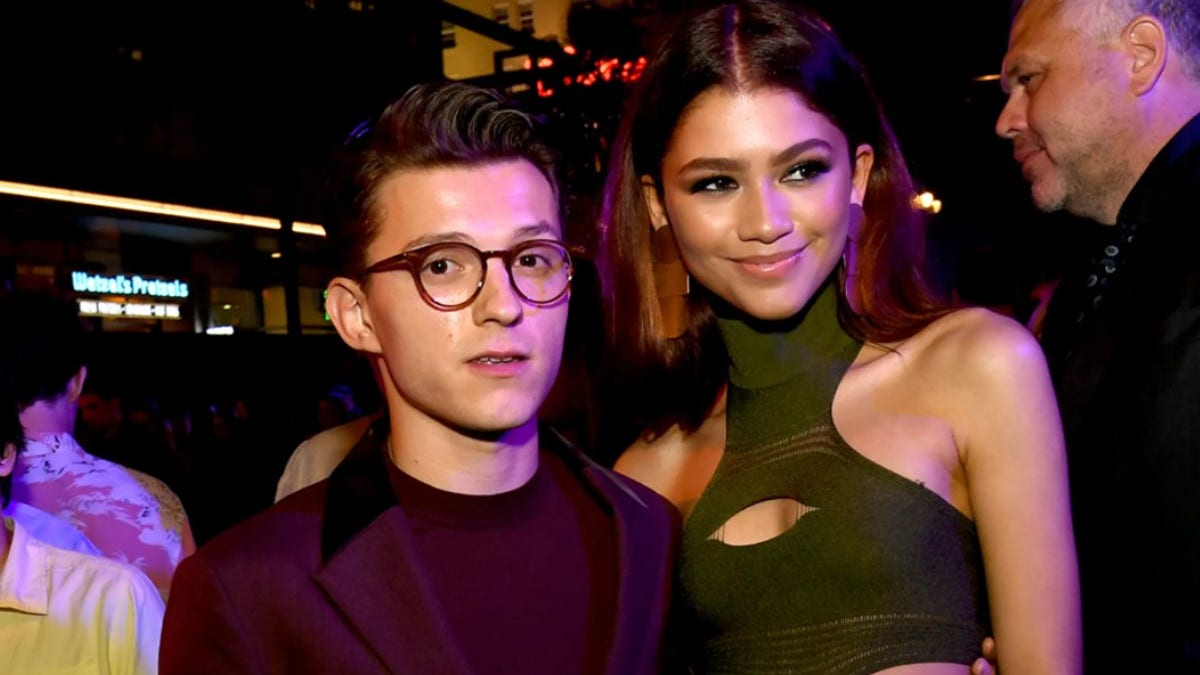 Tom Holland and Zendaya pose for a photo