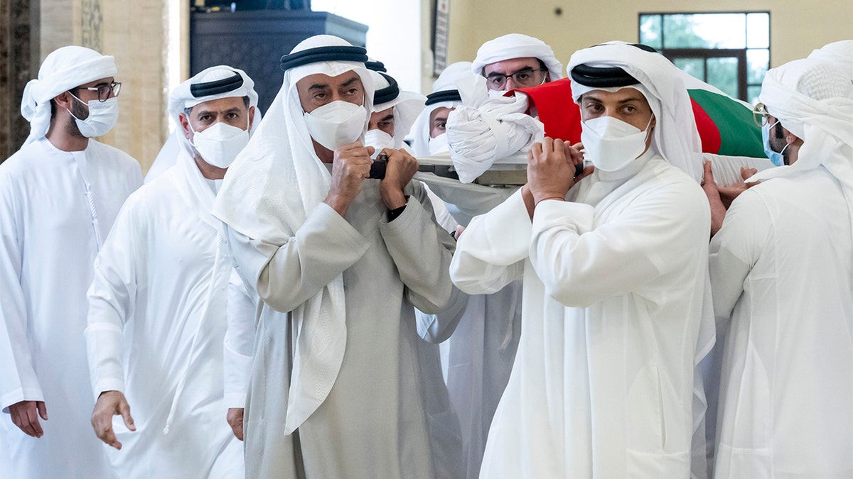 This photo made available by the Ministry of Presidential Affairs, shows Sheikh Mohamed bin Zayed Al Nahyan, ruler of Abu Dhabi, front left, and Sheikh Mansour bin Zayed Al Nahyan, UAE Deputy Prime Minister and Minister of Presidential Affairs, front right, carry the body of Sheikh Khalifa bin Zayed Al Nahyan, president of the United Arab Emirates, with other members of royal family at Sheikh Sultan bin Zayed The First mosque, in Abu Dhabi, Friday, May 13, 2022. (Hamad Al Kaabi/Ministry of Presidential Affairs via AP)
