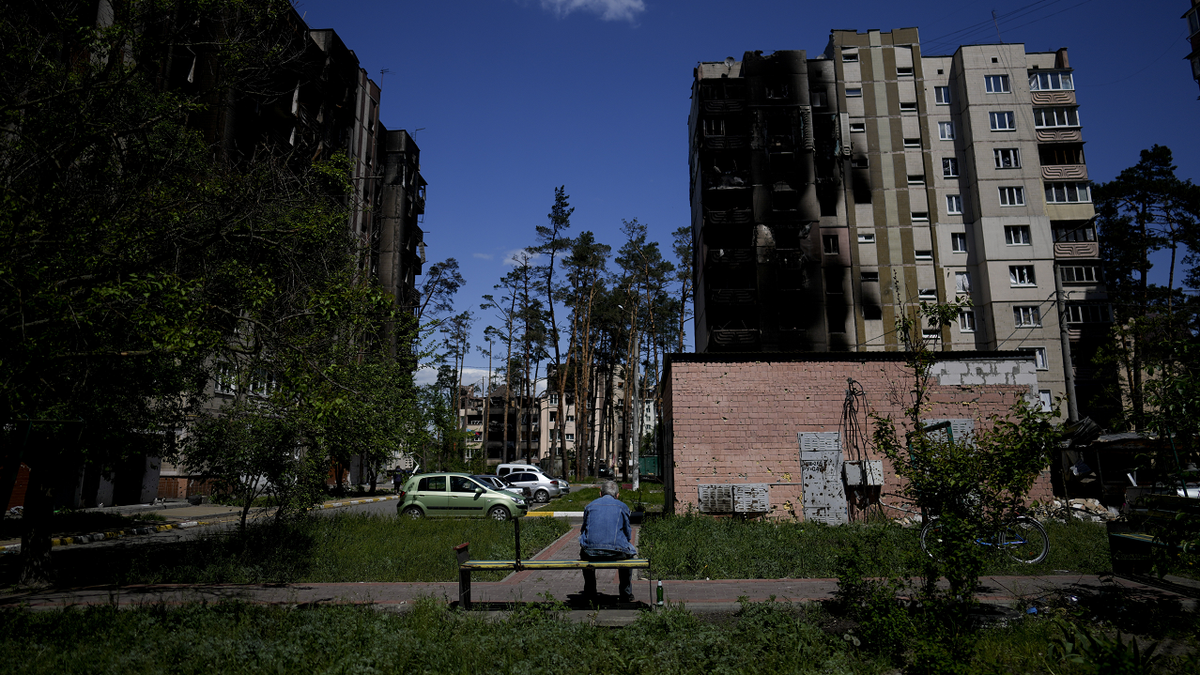 Ukraine citizen sits on bench in Irpin, outside of Kyiv