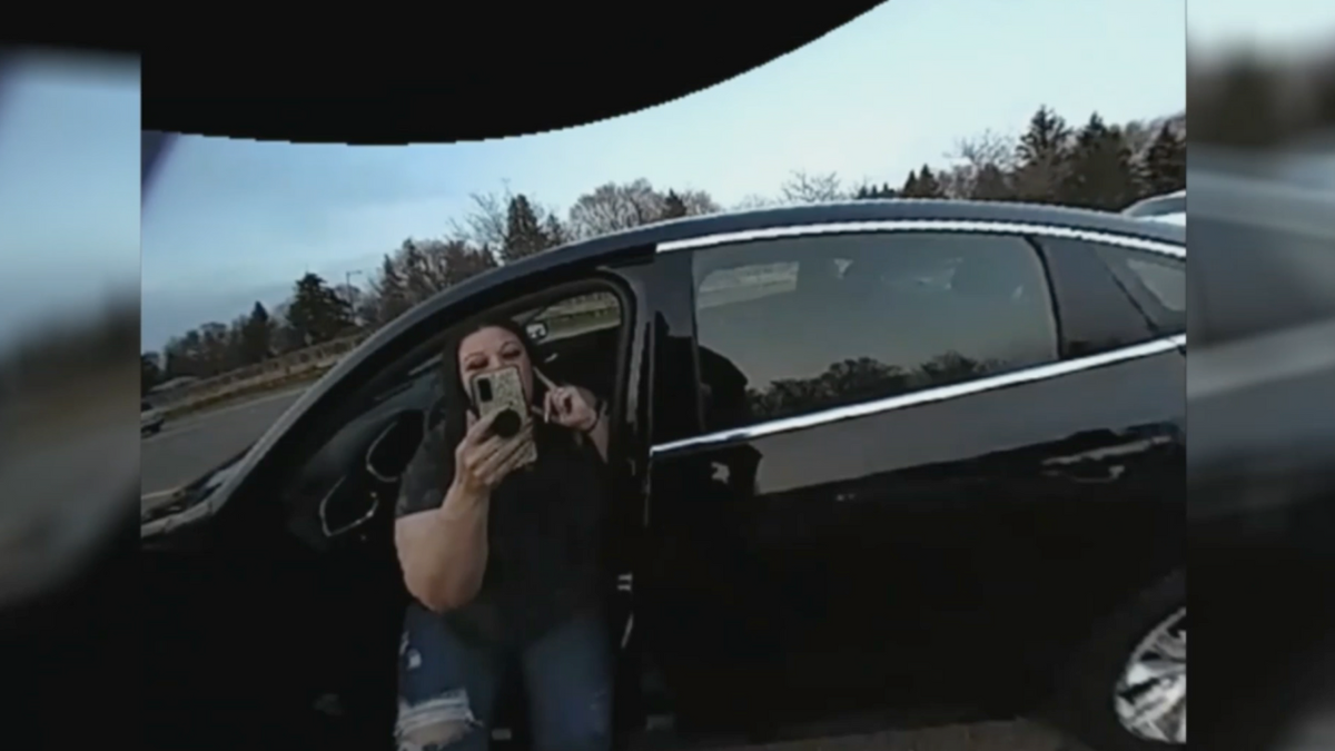 Police in Brooklyn Center, Minnesota released body camera video on Friday that shows an officer grabbing the phone of Daunte Wright's mother as she was recording officers performing a traffic stop on Wednesday.