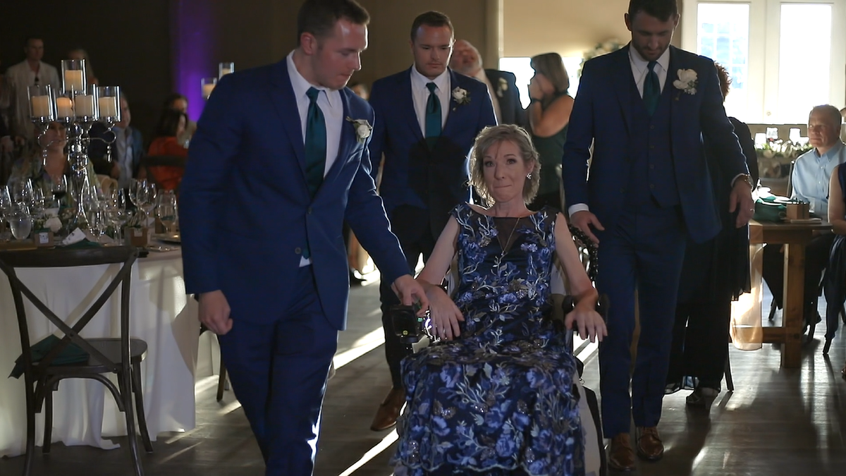 Zak Poirier, Nick Poirier and Jake Poirier escort their mother Kathy Poirier to the wedding dance floor