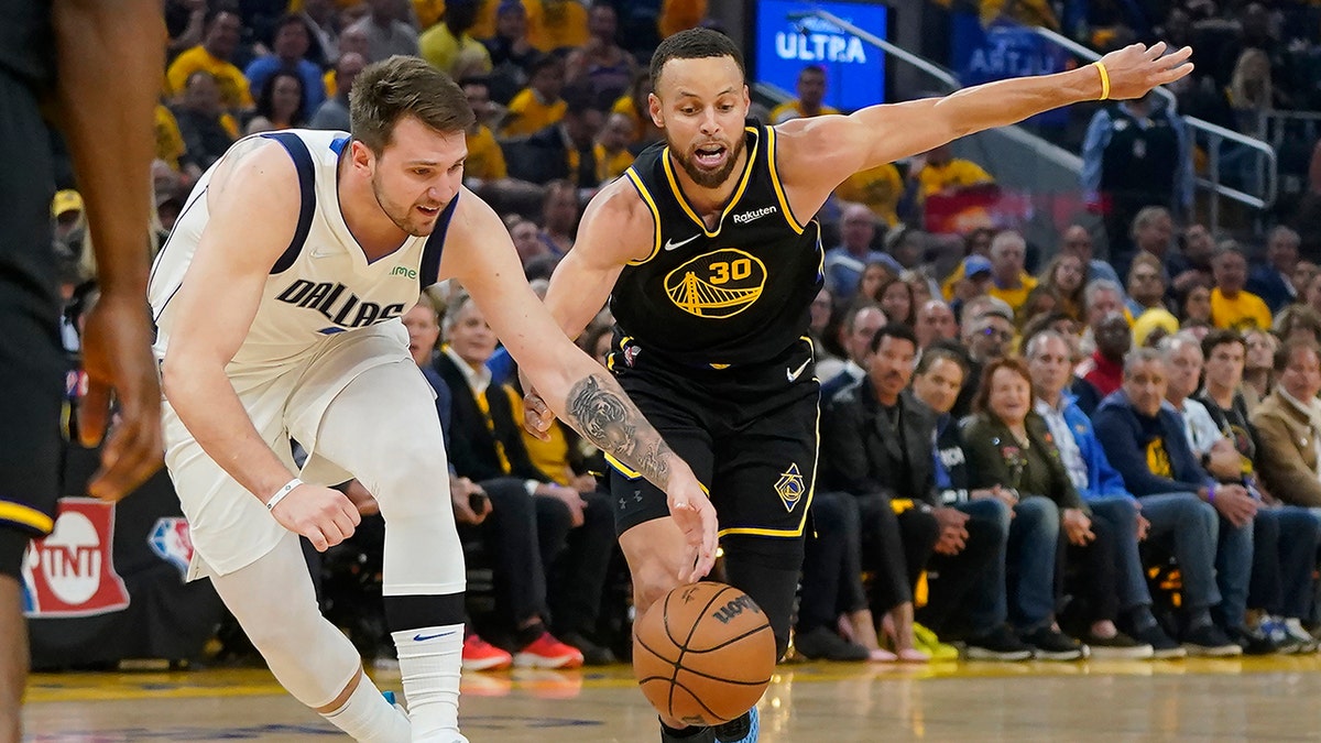 Dallas Mavericks guard Luka Doncic reaches for the ball during the Western Conference finals in San Francisco, Thursday, May 26, 2022.