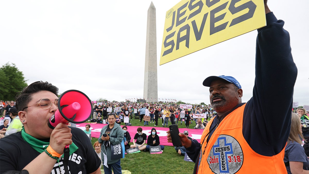 Abortion rights activist Cristela Luiz (L) confronts an anti-abortion demonstrator during a Bans Off Our Bodies rally at the base of the Washington Monument on May, 14 2022, in Washington. (Photo by Tasos Katopodis/Getty Images)