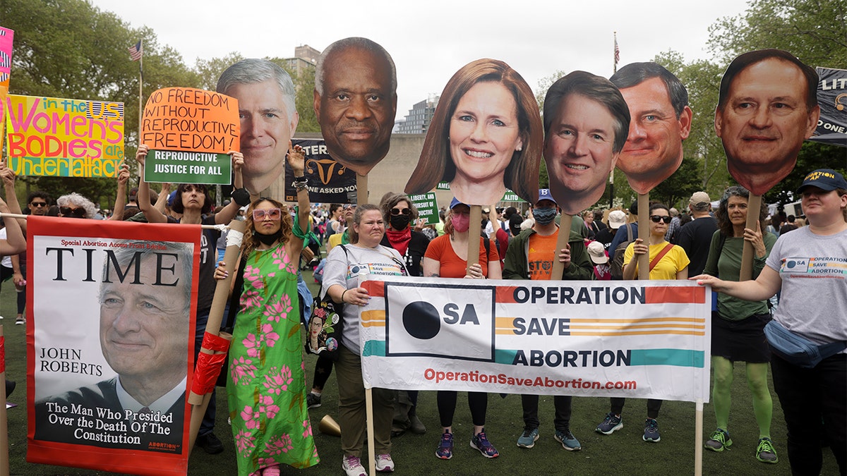 Protesters hold up signs during an abortion rights demonstration