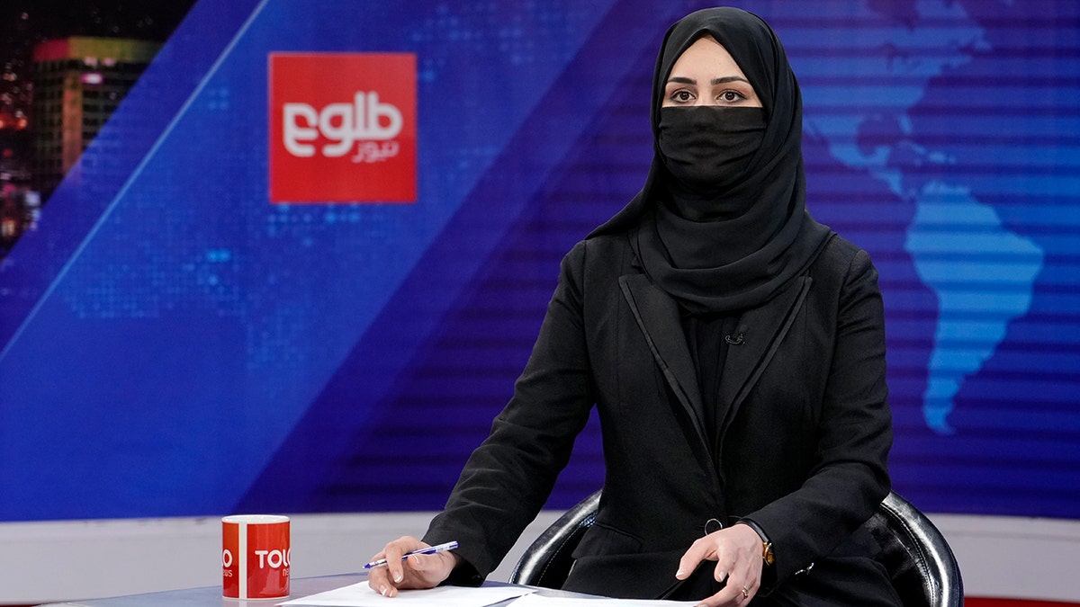 Iran TV anchor Khatereh Ahmadi covering her face