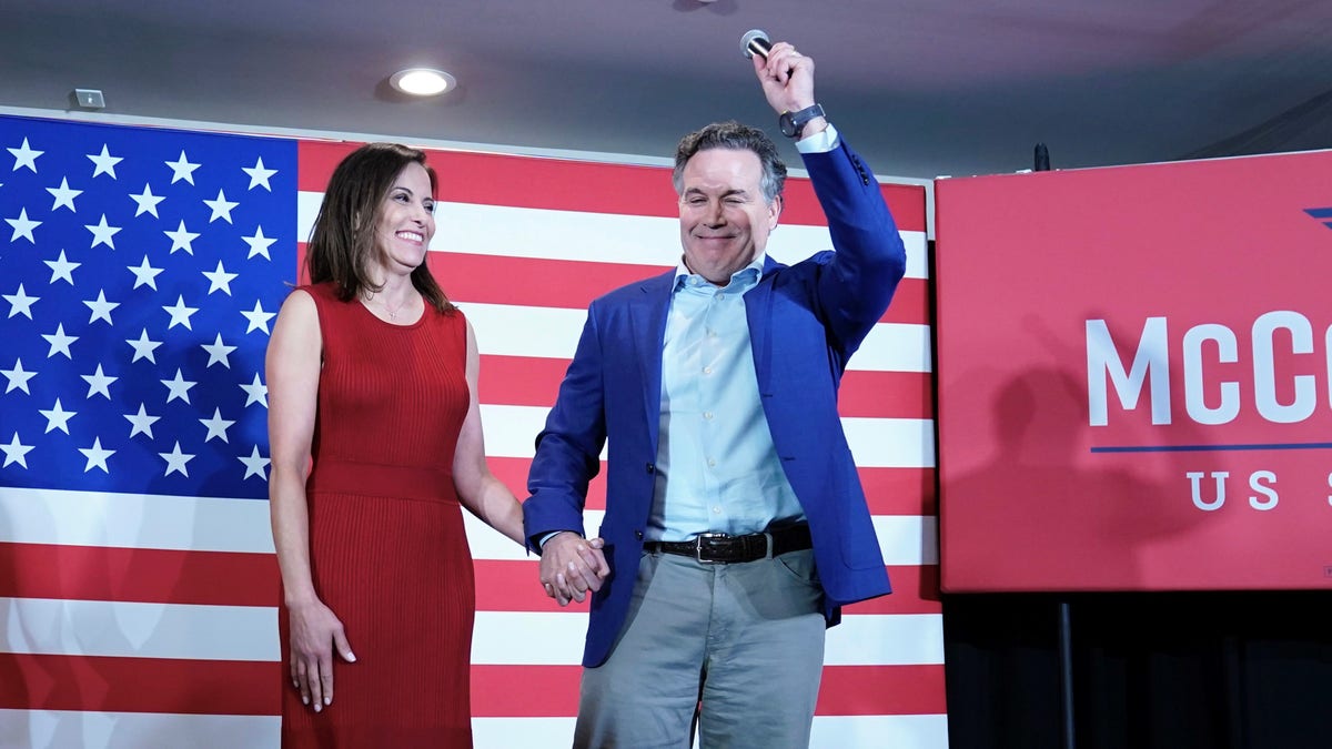 Dave McCormick and his wife Dinah Powell talk to supporters during his returns watch party in the Pennsylvania primary election, May 17, 2022, in Pittsburgh.