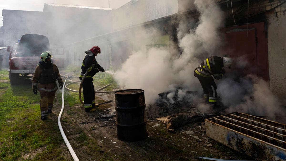 Ukrainian firefighters battle smoke from Russian attack