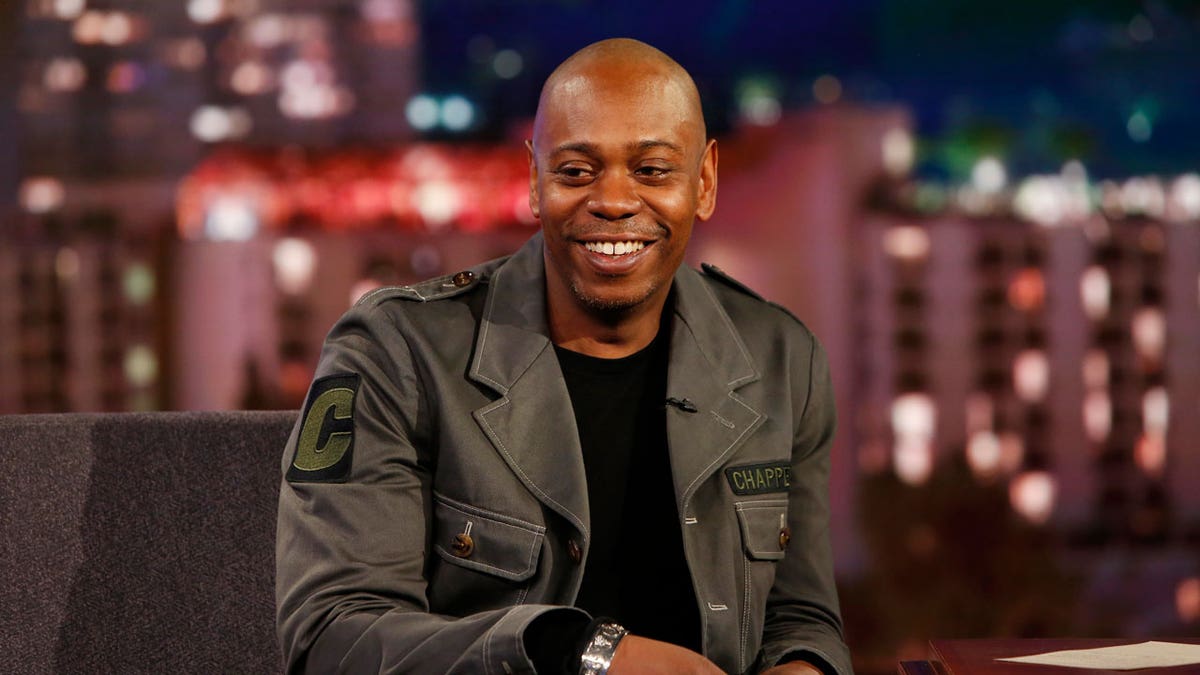 Dave Chappelle smiles on-stage