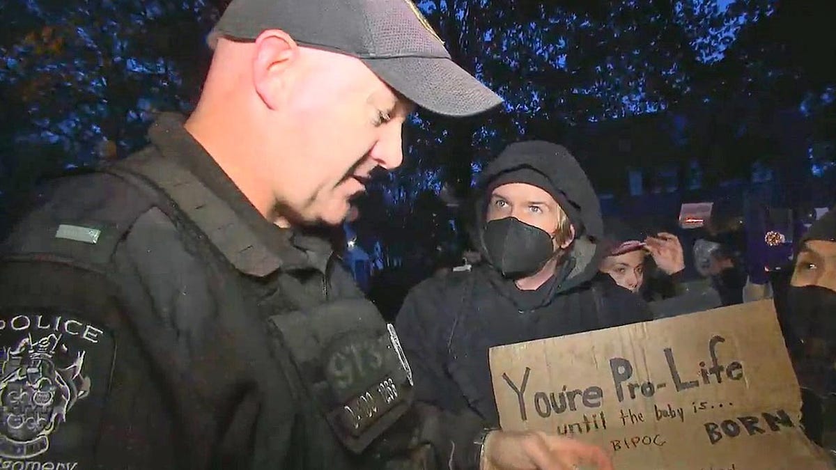 A police officer address a pro-choice protester