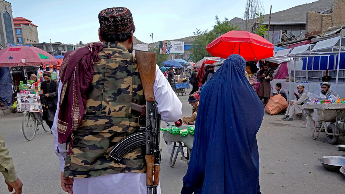 Woman and Taliiban fighter