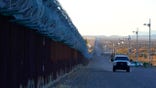 FILE - A U.S. Border Patrol vehicle drives along the border fence at the U.S.-Mexico border wall, on Dec. 15, 2020, in Douglas, Ariz. Authorities are investigating the cause of death of a female migrant whose leg was entrapped while using a climbing harness and ended up hanging upside down off the border wall in eastern Arizona. U.S. Customs and Border Protection officials offered few details, but the local sheriff's office said the woman was a 32-year-old Mexican who was attempting to cross the wall Monday, April 11, 2022 near Douglas, Arizona. Her name was not released.