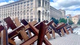 Steel barriers line the sidewalk in central Kyiv