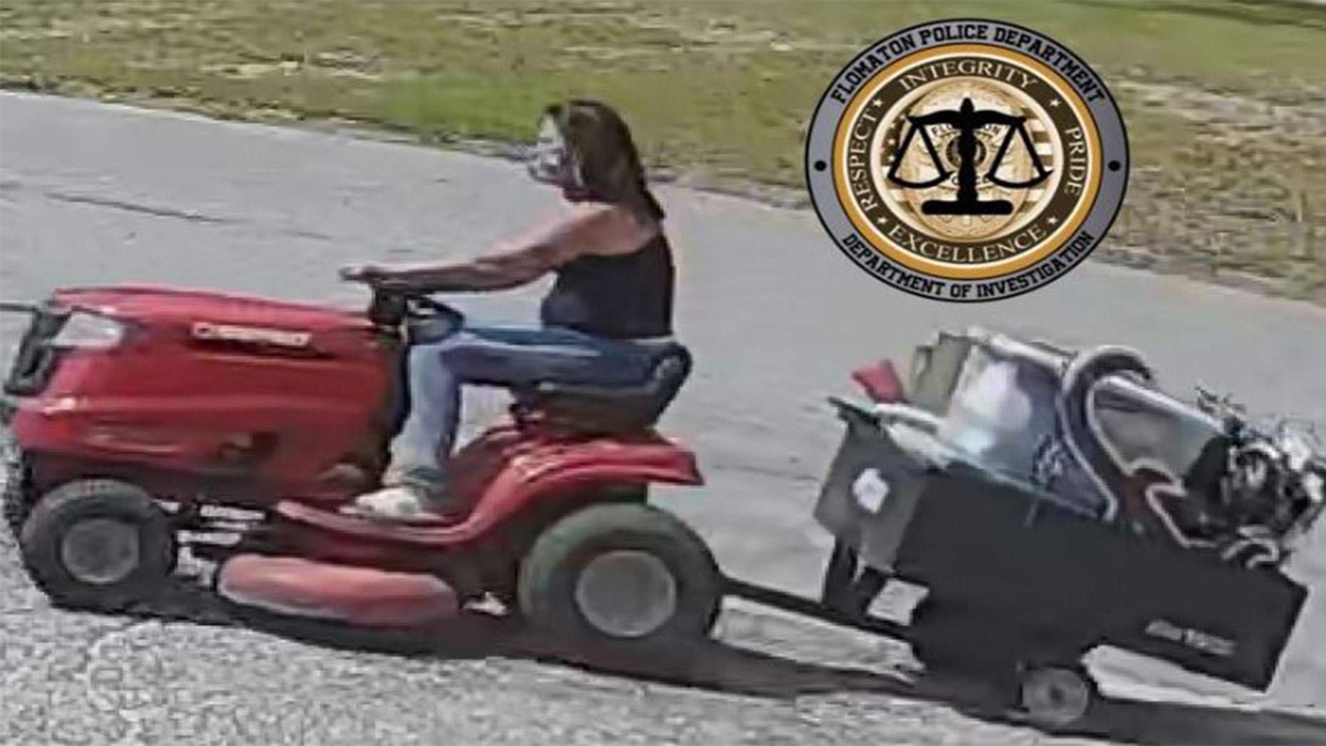 A woman riding a lawnmower
