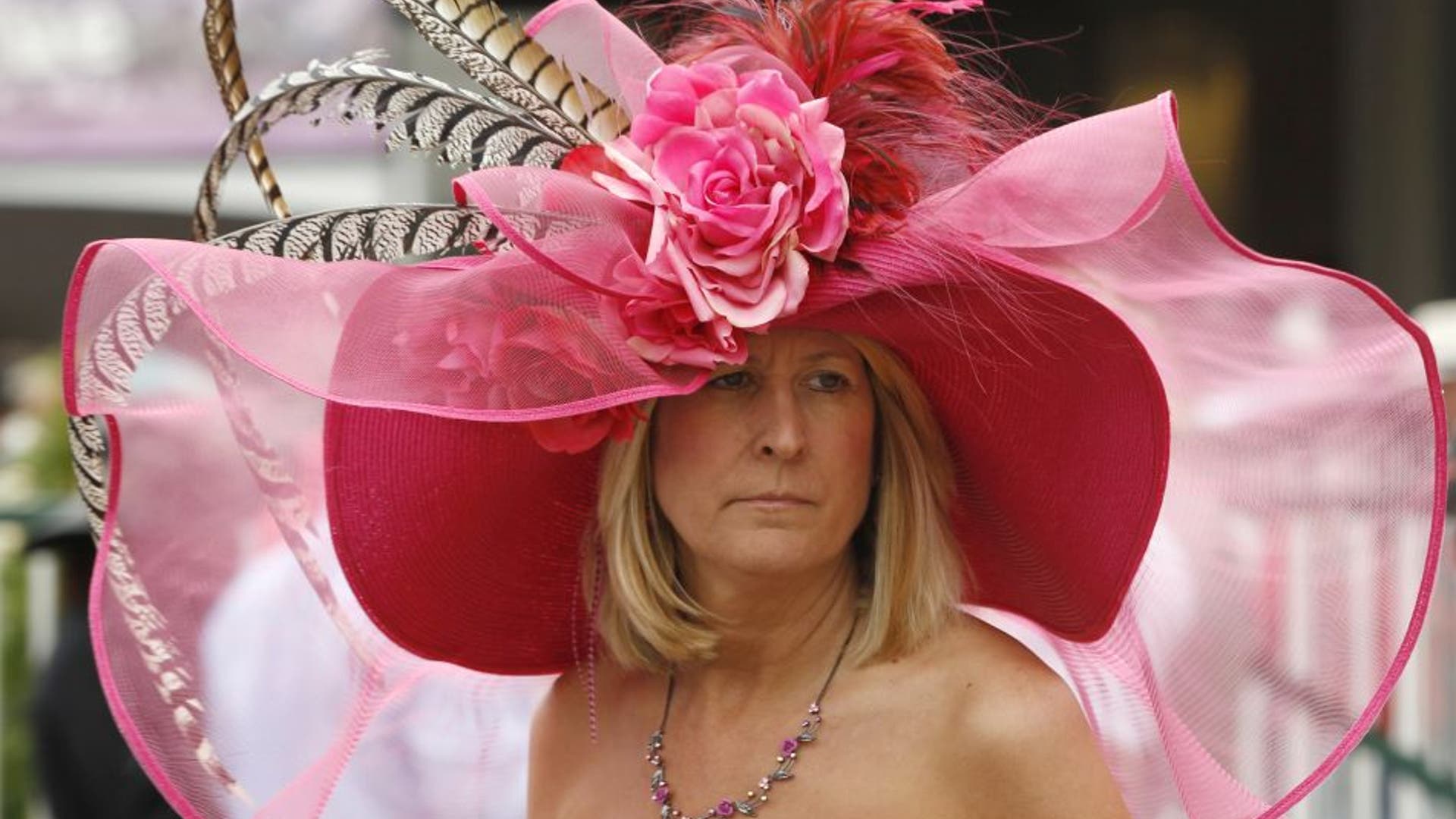 A race fan wears an elaborate pink hat with feathers and flowers for the Kentucky Derby at Churchill Downs in Louisville, Kentucky, on May 7, 2011.