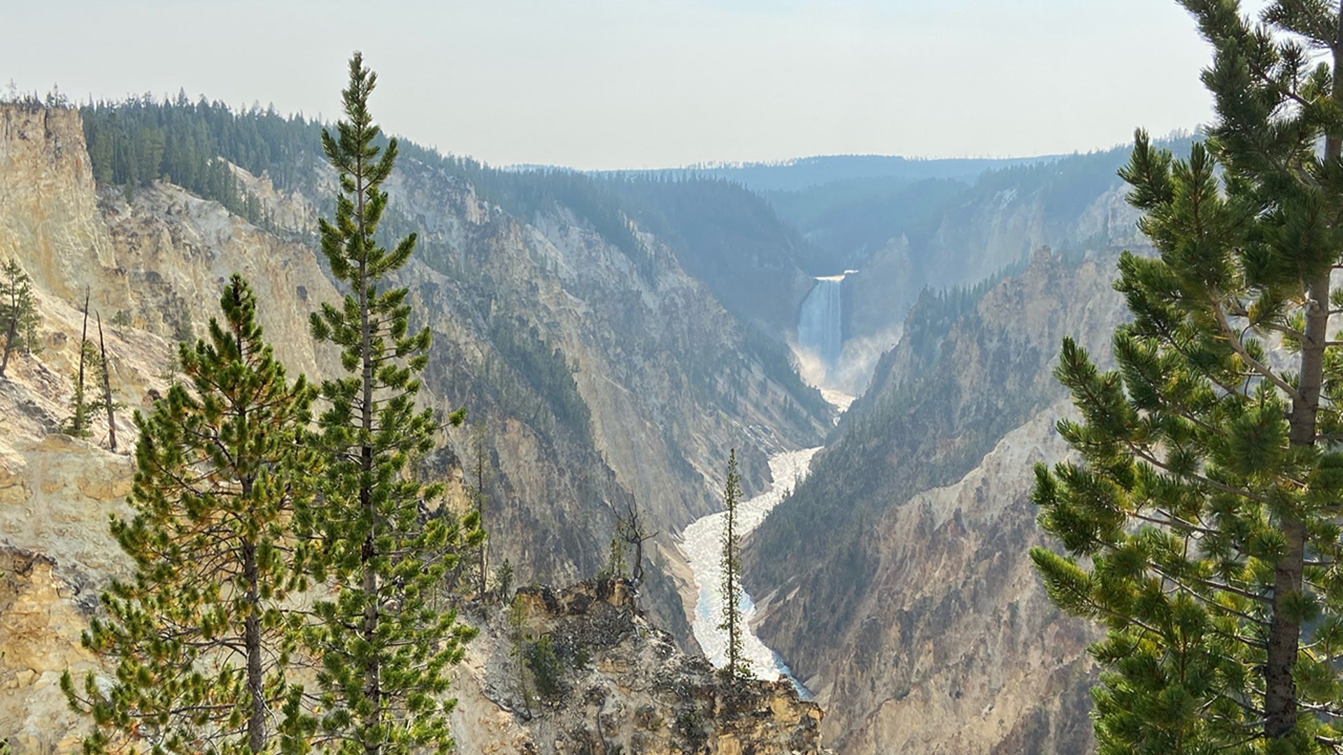 Yellowstone National Park landscape with Upper Falls of Yellowstone River in the distance.