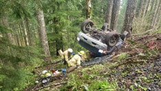 Oregon firefighters rescue 2 trapped in vehicle after rollover crash in remote area