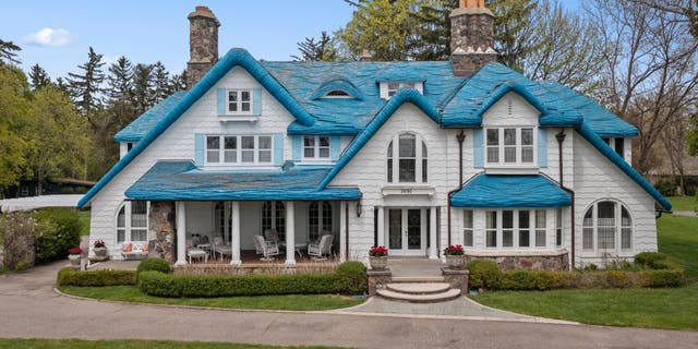 The "Smurf House" at 2690 Pine Lake Road is a blue roofed Cotswold-style home located in West Bloomfield Township, Michigan.