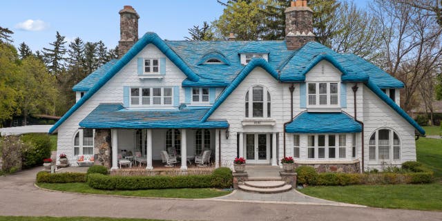 The "Smurf House" at 2690 Pine Lake Road is a blue roofed Cotswold-style home located in West Bloomfield Township, Michigan.