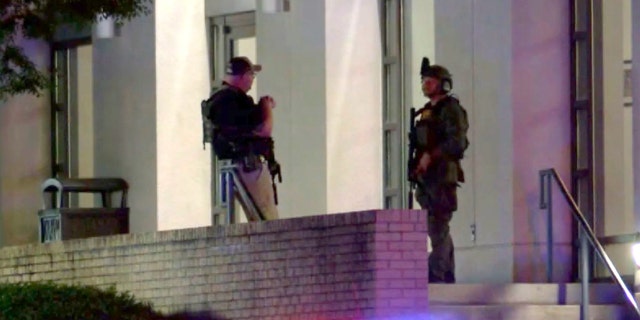 Armed police officers are seen outside the Hot Springs Convention Center in Arkansas after multiple people were shot following a high school graduation ceremony on Thursday, May 12, 2022.