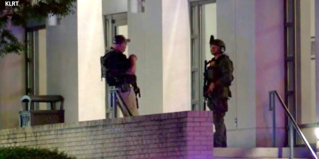 Armed police officers are seen outside the Hot Springs Convention Center in Arkansas after multiple people were shot following a high school graduation ceremony on Thursday, May 12, 2022.