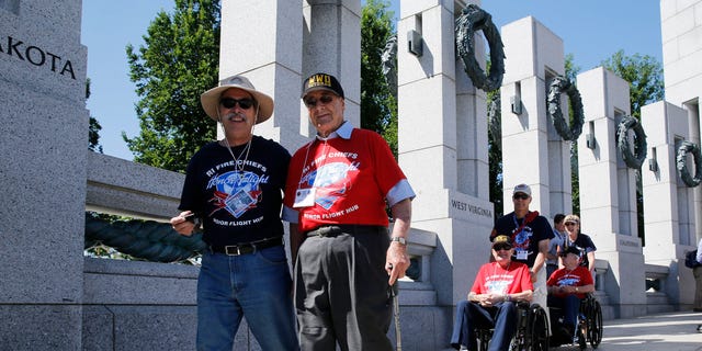 World War II veterans are escorted towards a ceremony at the National World War II Memorial marking the 70th anniversary of the D-Day invasion of Europe on June 6, 1944, while in Washington, June 6, 2014.