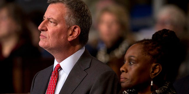New York Mayor Bill de Blasio and wife Chirlane McCray attend a midnight mass St Patrick's Cathedral in the Manhattan borough of New York, December 25, 2014.