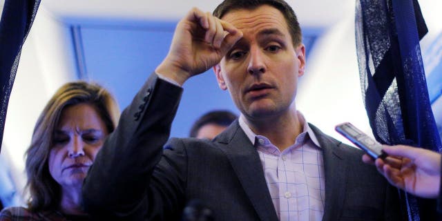 Robby Mook, Campaign Manager for U.S. Democratic presidential nominee Hillary Clinton, and Communications Director Jen Palmieri (L), talk to reporters onboard the campaign plane enroute to Cedar Rapids, Iowa, U.S. October 28, 2016.