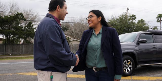 Democrat Jessica Cisneros, who is campaigning for a House seat, greets her opponent, U.S. Rep. Henry Cuellar, D-Texas, for the first time on the campaign trail at the Citrus Parade in Mission, Texas, Jan. 25, 2020. 