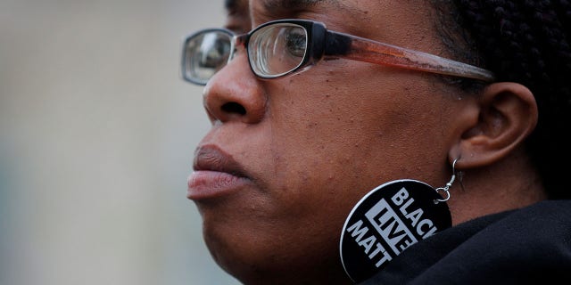 Activist Monica Cannon-Grant waits to speak at a demonstration one day after the guilty verdicts against former Minneapolis police officer Derek Chauvin in the death of George Floyd, in Boston, April 21, 2021.