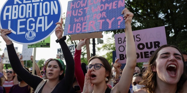 Demonstrators hold signs during a protest outside the U.S. Supreme Court, after the leak of a draft majority opinion written by Justice Samuel Alito preparing for a majority of the court to overturn the landmark Roe v. Wade abortion rights decision later this year, in Washington, D.C., on May 3, 2022. REUTERS/Evelyn Hockstein