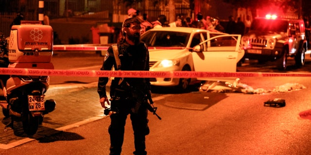 An Israeli police officer works at the scene following an incident in Elad in central Israel, May 5, 2022. 