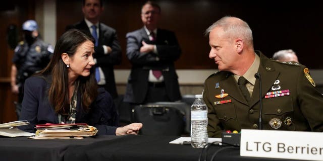 Director of National Intelligence (DNI) Avril Haines and Defense Intelligence Agency Director Lt. Gen. Scott Berrier confer before testifying in a Senate Armed Services Committee hearing on "Worldwide Threats" at the U.S. Capitol in Washington May 10, 2022.