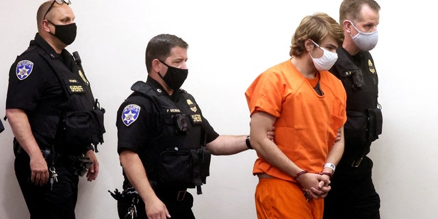 Buffalo shooting suspect, Payton S. Gendron, who is accused of killing 10 people in a live-streamed supermarket shooting in a Black neighborhood of Buffalo, is escorted in the courtroom in shackles, in Buffalo, New York, NOI., Maggio 19, 2022.