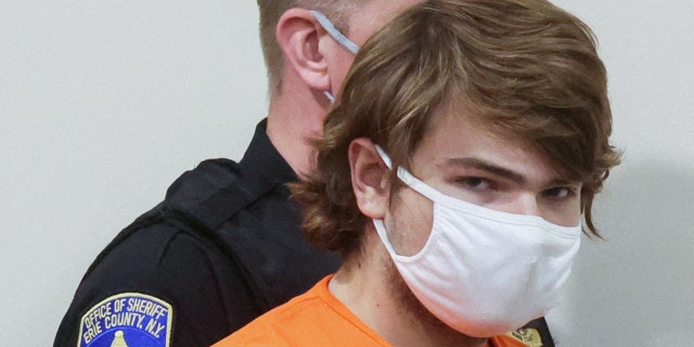 Buffalo shooting suspect, Payton S. Gendron, who is accused of killing 10 people in a live-streamed supermarket shooting in a Black neighborhood of Buffalo, is escorted in the courtroom in shackles, in Buffalo, New York, U.S., May 19, 2022.