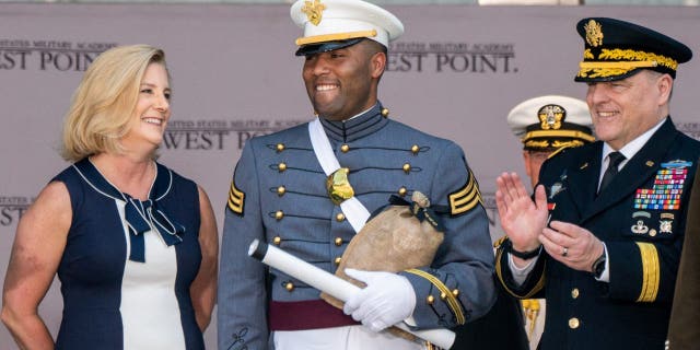 U.S. Military Academy graduating cadet Isaac Jefferson Dixon IV from Oceanside, CA is applauded by U.S. Army General Mark A. Milley, chairman of the Joint Chiefs of Staff, next to Christine Wormuth, Secretary of the Army, during the U.S. Military Academy's Class of 2022 graduation ceremony at West Point, New York, May 21, 2022.