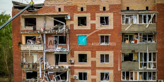 Rescue workers inspect an apartment building damaged in an overnight missile strike in Sloviansk, Ukraine, Tuesday, May 31.