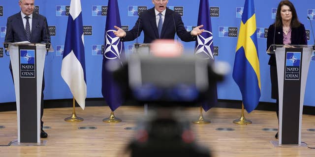 NATO Secretary General Jens Stoltenberg, center, takes part in a press conference with Finnish Foreign Minister Pekka Haavisto and Swedish Foreign Minister Ann Linde at NATO Headquarters in Brussels on Monday 24 january.