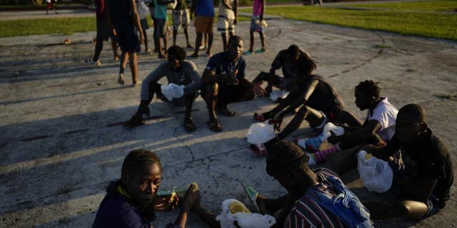 Haitian migrants eat at a tourist campground in Sierra Morena, in the Villa Clara province of Cuba Wednesday, May 25, 2022.