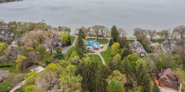 The blue roof on the 'Smurf House' stands out against other houses in the Pine Lake area.