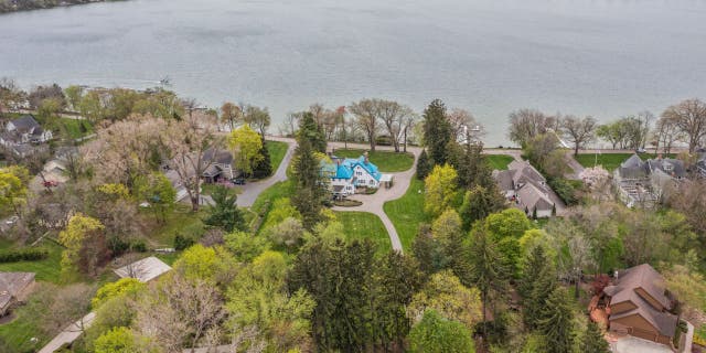 The blue roof on the 'Smurf House' stands out against other houses in the Pine Lake area.