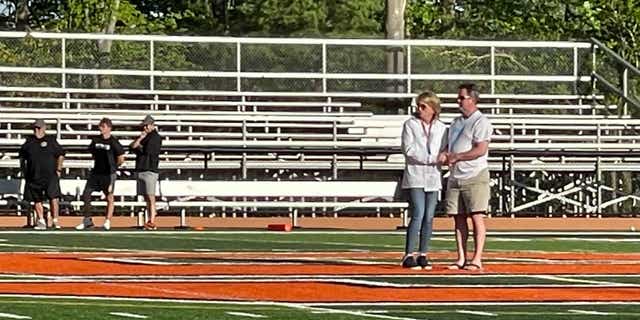 Jimmy’s parents hold hands at center field during the pre-game ceremony. 