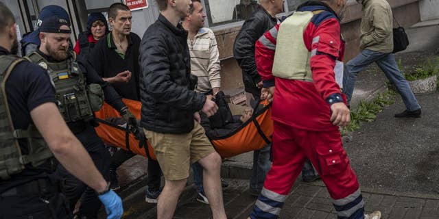 An injured man as a result of shelling is carried on a stretcher in Kharkiv, eastern Ukraine, on Thursday, May 26.